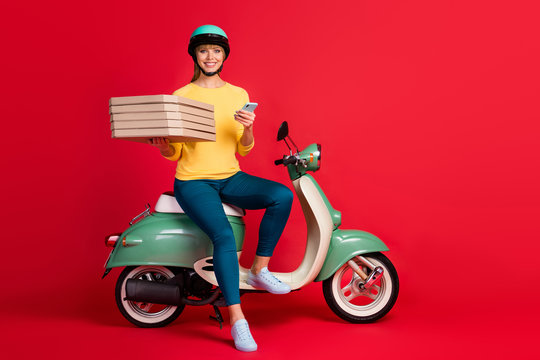 Full length body size view of her she nice attractive cheerful cheery girl  sitting on moped bringing italian bakery using 5g app purchase isolated on  bright vivid shine vibrant red color background