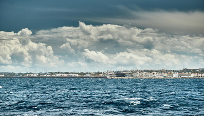 Spain, Formentera, 29 April 2018: The harbor of famous Formentera, a lighthouse, azure water, boats, sunny weather, without people