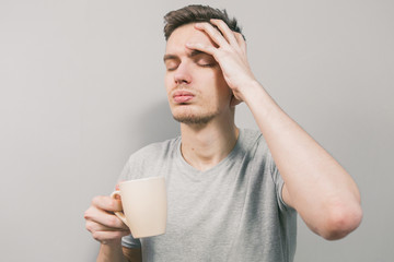 The young guy on a light background depicts different emotions