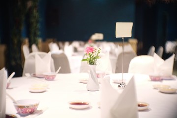 Table setting for dinner in white color Inside Restaurant.