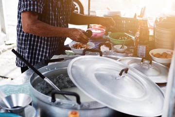 Man cooking Congee or Rice porridge , simple Asian Thai breakfast.