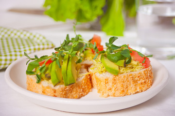sliced avocado on toast bread with herbs.