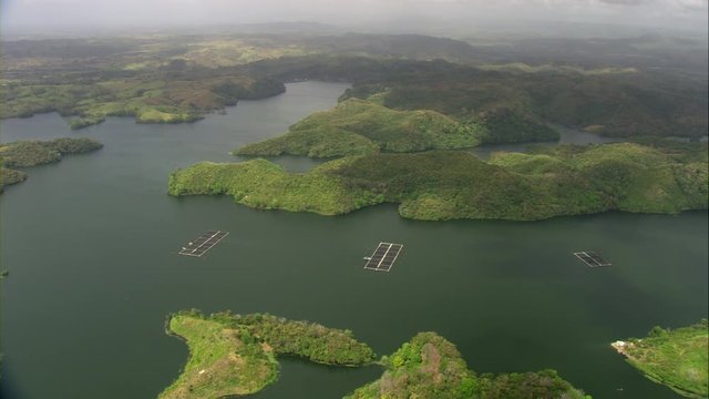 Aerial view of Lake Bayano in the Panama Canal, small islands with palms and cloud forest and mountains in the background, in Panama, Central America, filmed with Cineflex stabilization camera system 