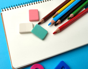open notebook in the middle with blank white sheets, top view, concept of back to school