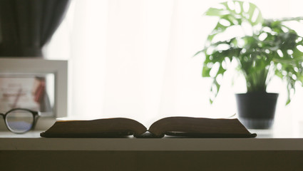 Selective focus of the holy bible with sunlight.