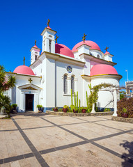 Fototapeta na wymiar Snow-white church with pink domes