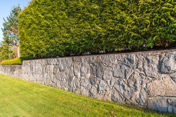 Fence built from trees and stones. Outdoor landscape. Security and privacy concept. Vancouver....
