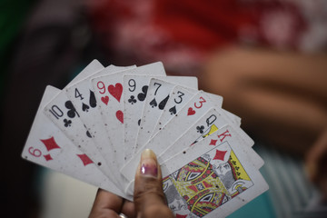playing cards on a women hand 