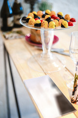 candies in multi-colored glaze lie on a glass stand