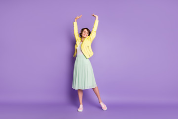 Full length photo of charming funky girl enjoy weekend holiday free time raise stretch hands close eyes feel rejoice wear good look outfit sneakers isolated over bright color background