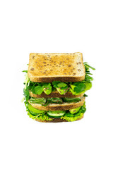 Delicious vegan sandwich with green vegetables and herbs isolated on a white background. Whole grain sandwich, healthy food.