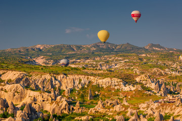Flying balloons over amazing rock forms in Cappadocia