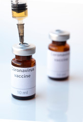 The photo illustration shows two vials labeled Coronavirus vaccine and syringe.