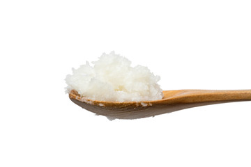 Wooden spoon with with a heap of white coconut oil