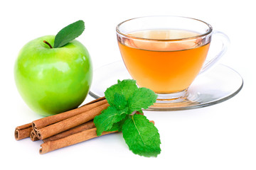 Glass of apple cider tea , fresh ripe granny smith green apple fruit and cinnamon stick with mint green leaf isolated on white background. 
