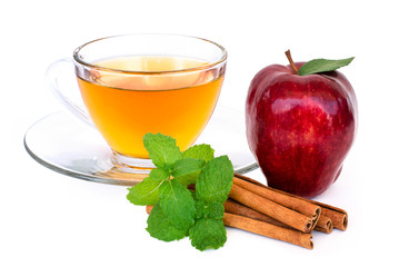 glass of apple cider tea , fresh ripe red washington apple fruit and cinnamon stick with mint green leaf isolated on white background. 