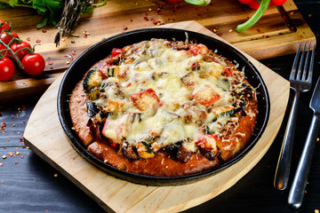homemade pizza in a pan from the oven with vegetables