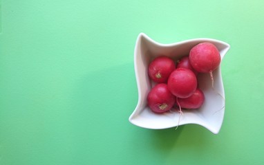 Radish on a white small plate