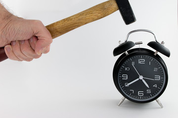 Vintage Alarm Clock with Hammer about to hit on white background