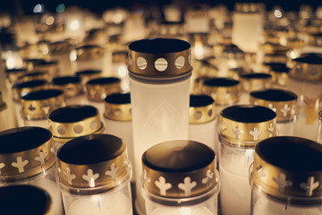 Many candles kindling at a cemetery on All Saints' Day