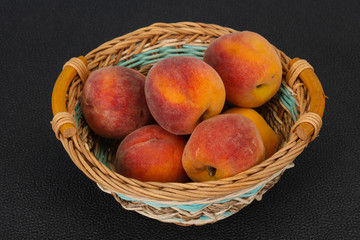 Peach heap in the wooden basket