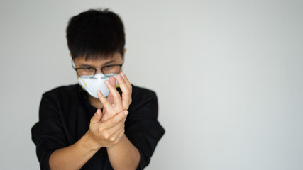 The young man wearing face hygienic mask. Close up isolated clean and rub dirty hands fingers spray alcohol, antiseptic and soap for sanitize,protect people from coronavirus or covid-19. Man and women