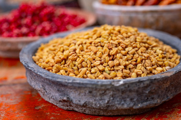 Indian spices collection, dried fenugreek seeds and another spices in clay bowls
