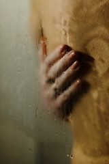 A woman hugs a man in the shower.