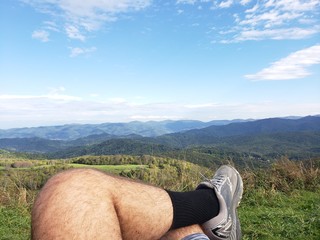 man sitting on top of mountain