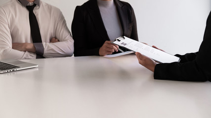 Interview employee talking about resume and job description with the job seeker sitting in front