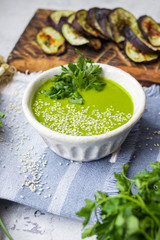 Green peas cream soup with sesame seeds and parsley.