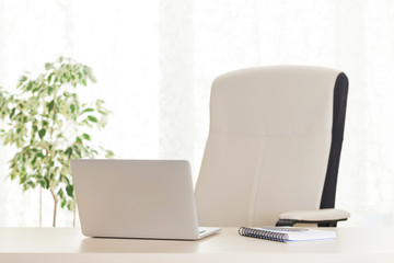 Home office workplace with laptop and supplies