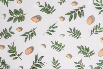 Creative flat lay composition with easter eggs and natural branches. Natural sun light lighting and sharp shadows. Realistic aesthetic look pattern. Contemporary style.