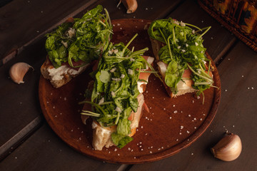 homemade bread bruschettas with raw ham and arugula salt and garlic
