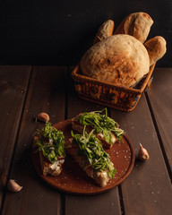 homemade bread bruschettas with raw ham and arugula salt and garlic