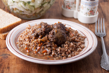   Meatballs in sauce with buckwheat garnish