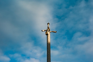 CCTV cameras on a metal pole overlooking streets, cloud sky background