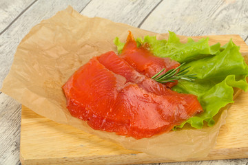 Sliced salmon fillet served rosemary