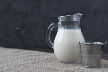 Milk in a jug. Village milk in a bucket.