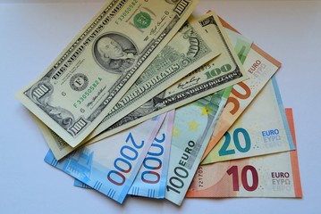  Dollars, euros and rubles banknotes on the table.