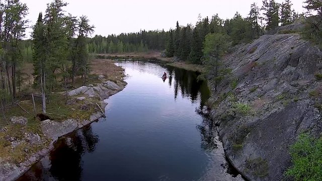 Paddling a river between two lakes in the rocky Canadian Shield country of eastern Manitoba.