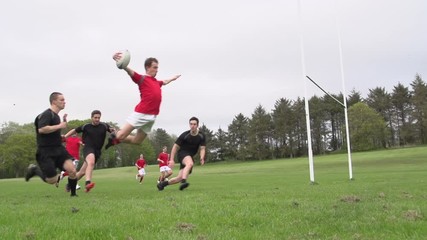 Scoring a try in Rugby. Action from a match resulting in one of the teams getting the ball over the line. with a huge dive. Slow motion. Stock Video Clip Footage