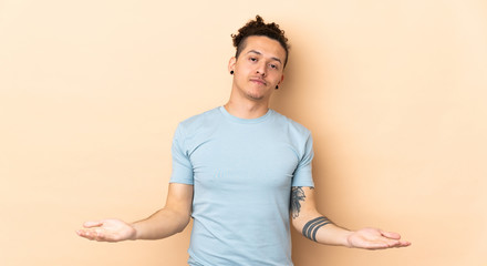 Caucasian man over isolated background having doubts