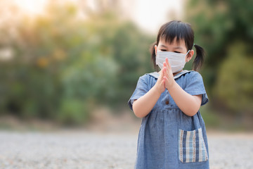 Cute Asian girls wear masks to protect against covid-19 viruses and Pm2.5 air pollution and wash their hands with alcohol gel to protect against covid-19 virus outbreak. Coronavirus concept.