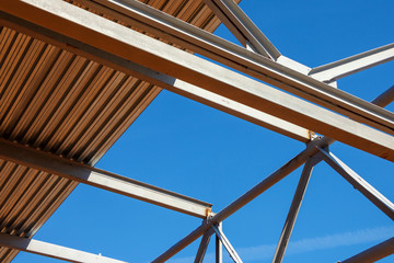 Steel architectural structure of iron beams and corrugated board against a blue sky
