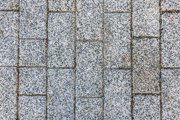 Masonry of gray as smooth as a brick of sidewalk stone