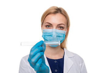 A girl doctor in a medical mask and gloves holding test tube on a white background