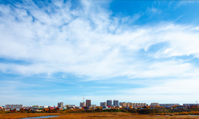 Full frame of blue sky with clouds and city view of the metropolis