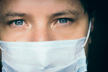 Young white man wears a medical mask during quarantine at his home, Bogotá, April 1, 2020