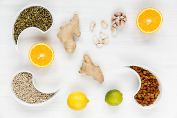 The fight against viruses with natural remedies, a tasty cure for flu and coldsoranges, ginger, garlic, sunflower seeds, pumpkin seeds, lime, lemon and raisins. Environmental antiviral drugs.